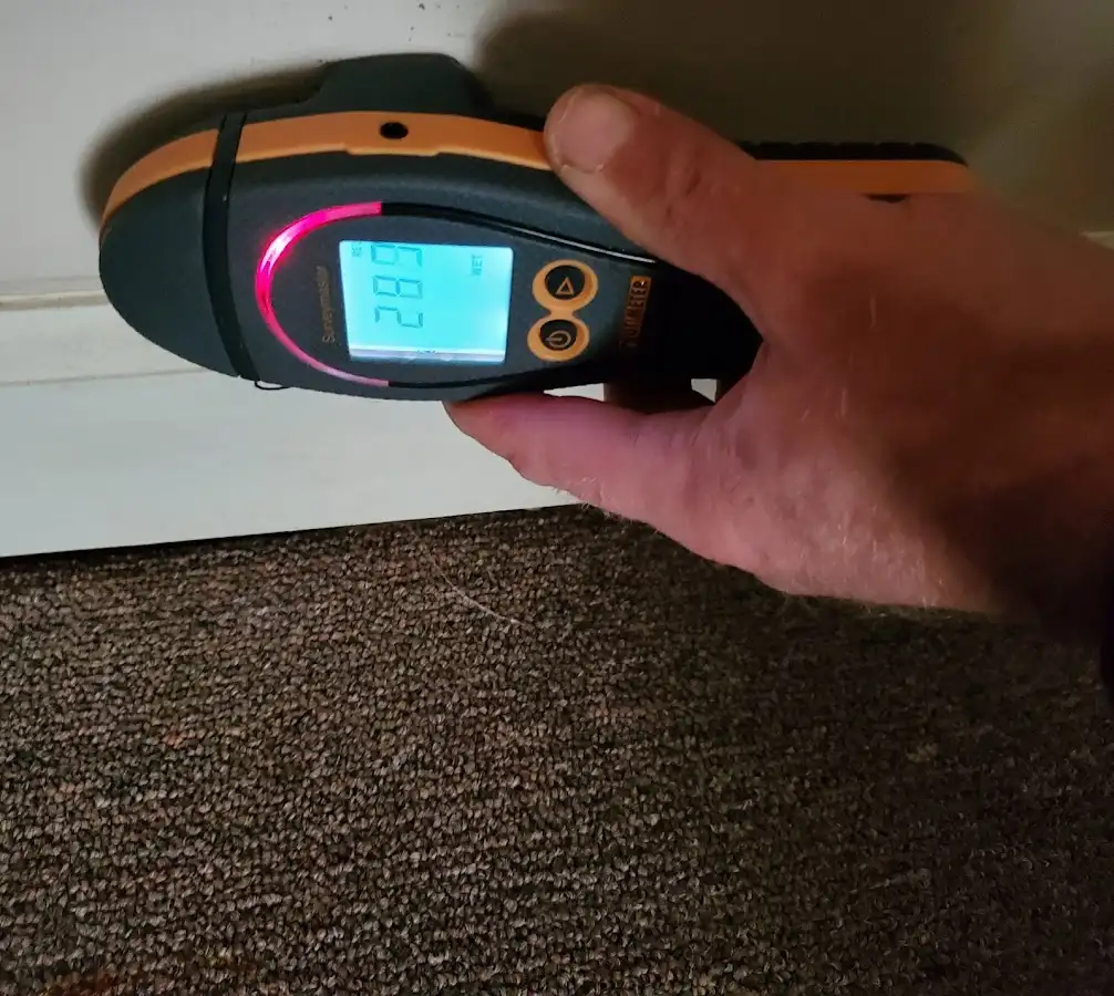 Moisture detection at baseboard during Storm Damage Restoration in Jackson